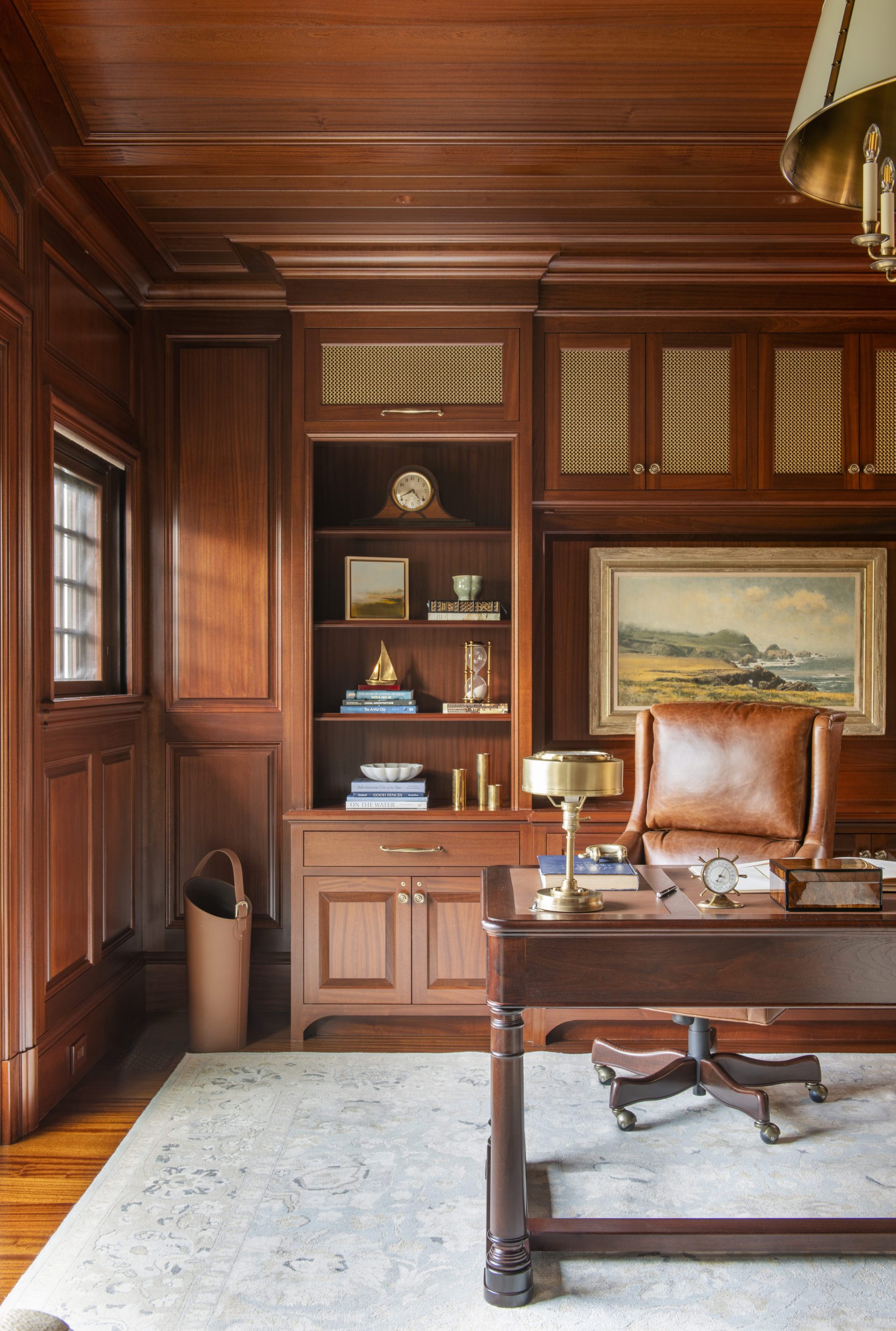A luxury home office with mahogany paneling designed by Taste Design Inc New York