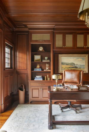 A luxury home office with mahogany paneling designed by Taste Design Inc New York
