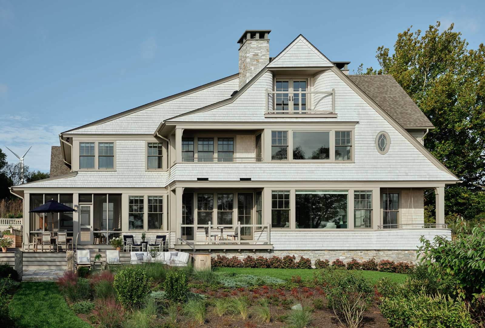 The back exterior of a contemporary shingle-style home.