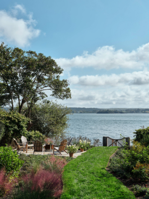 The view to the water access and firepit of a family home.