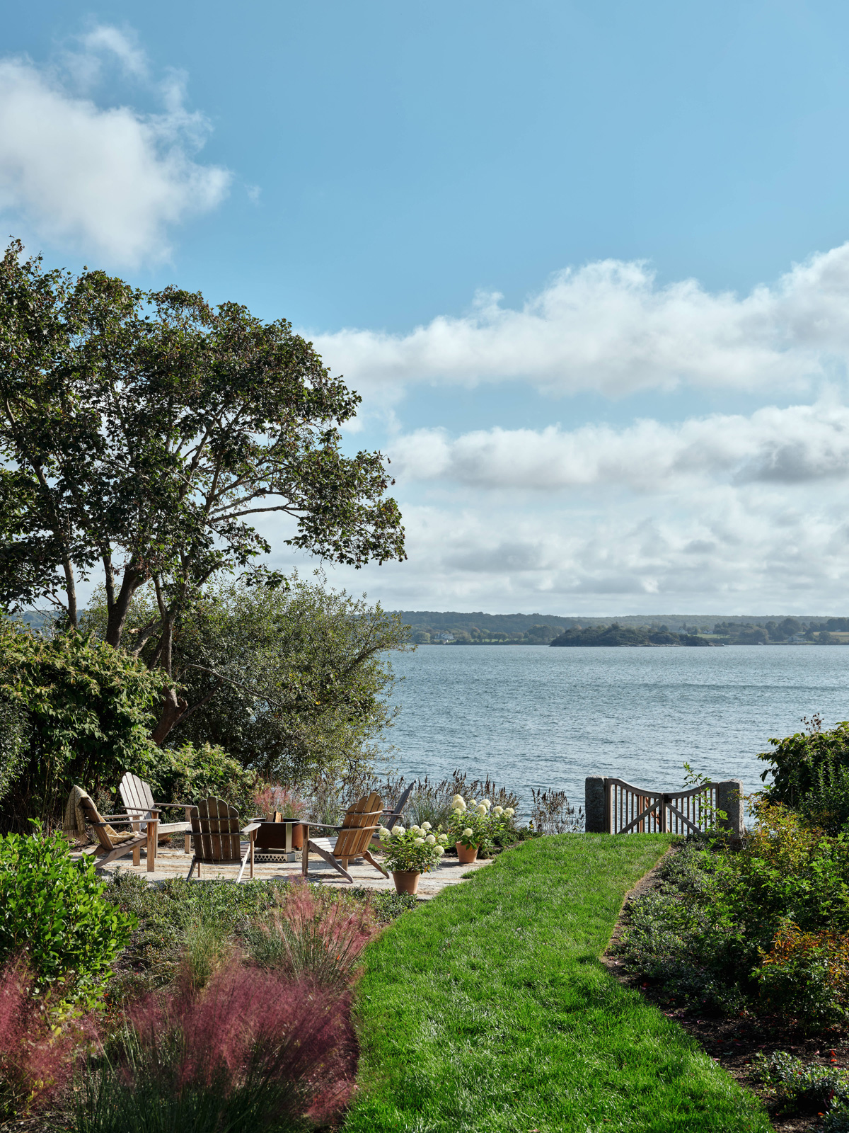 The view to the water access and firepit of a family home.