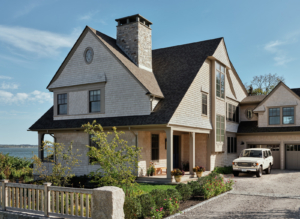 A gravel driveway leading up to a family home