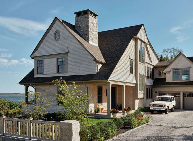A gravel driveway leading up to a family home