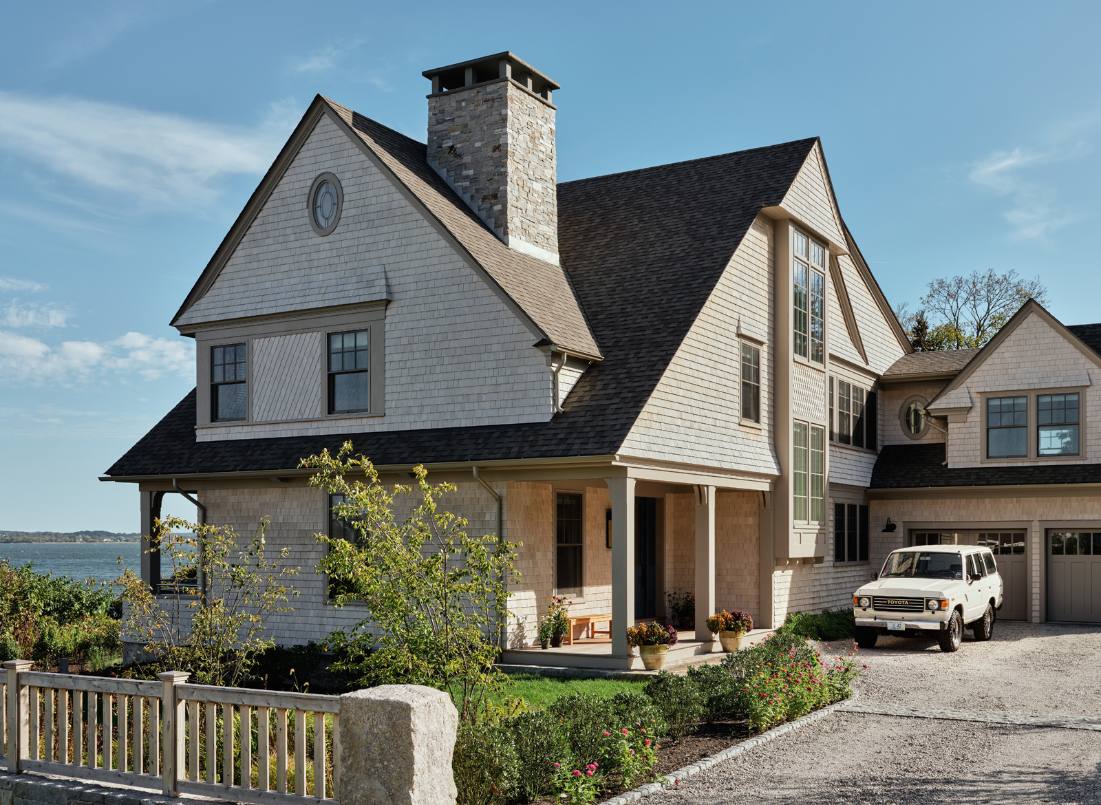 A gravel driveway leading up to a family home