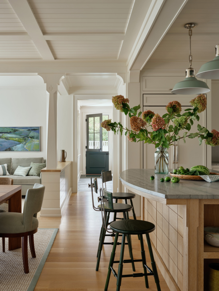 A hallway between the kitchen island and dining room of a new construction custom home.