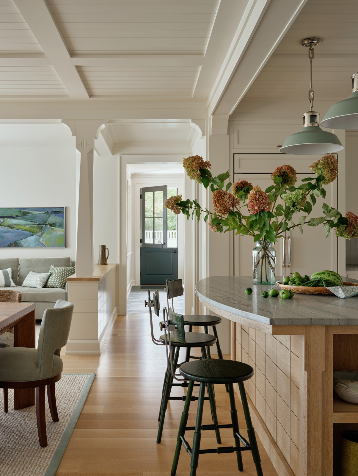 A hallway between the kitchen island and dining room of a new construction custom home.