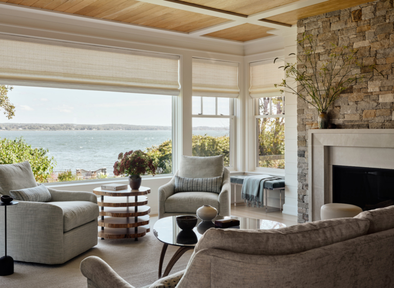 A living room with cerused oak coffered ceilings and fieldstone fireplace.