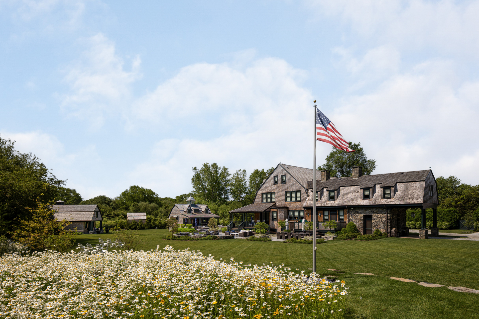 A shingle-style farmhouse and family compound by Taste Design in Rhode Island