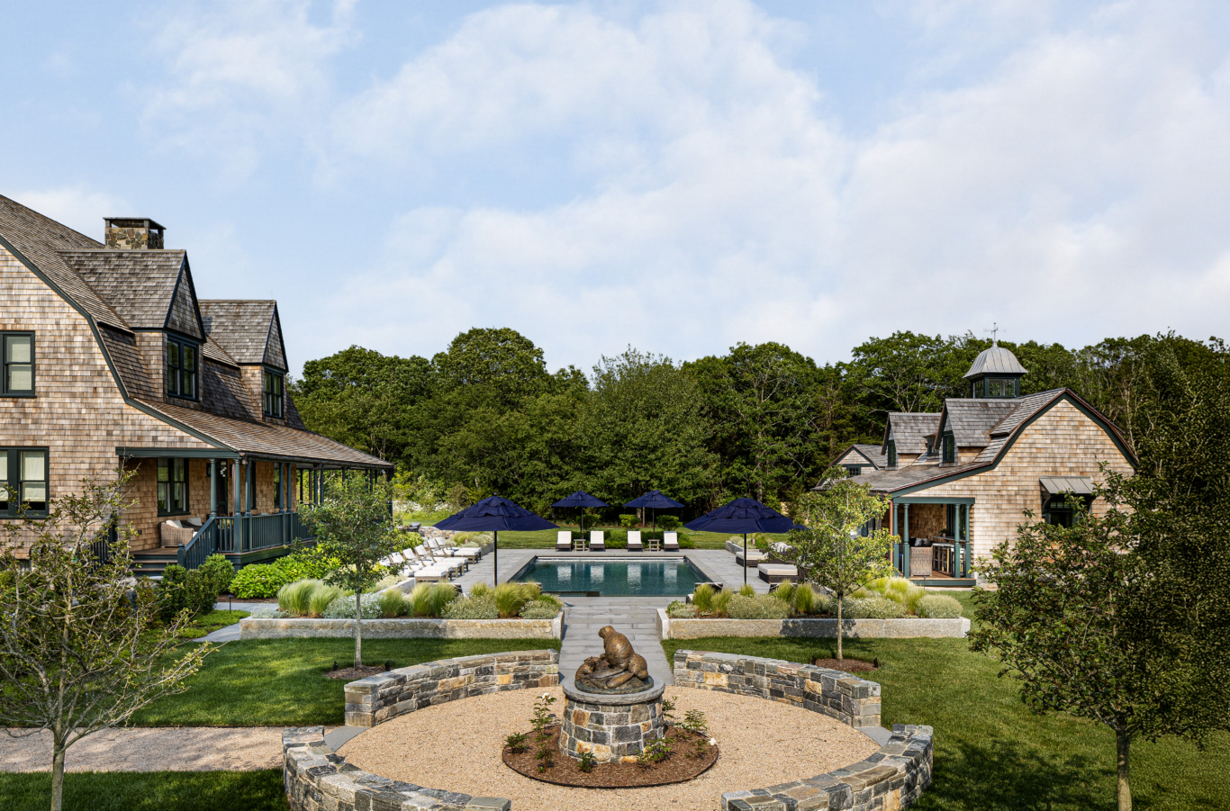A summer family compound with pool and multiple structures