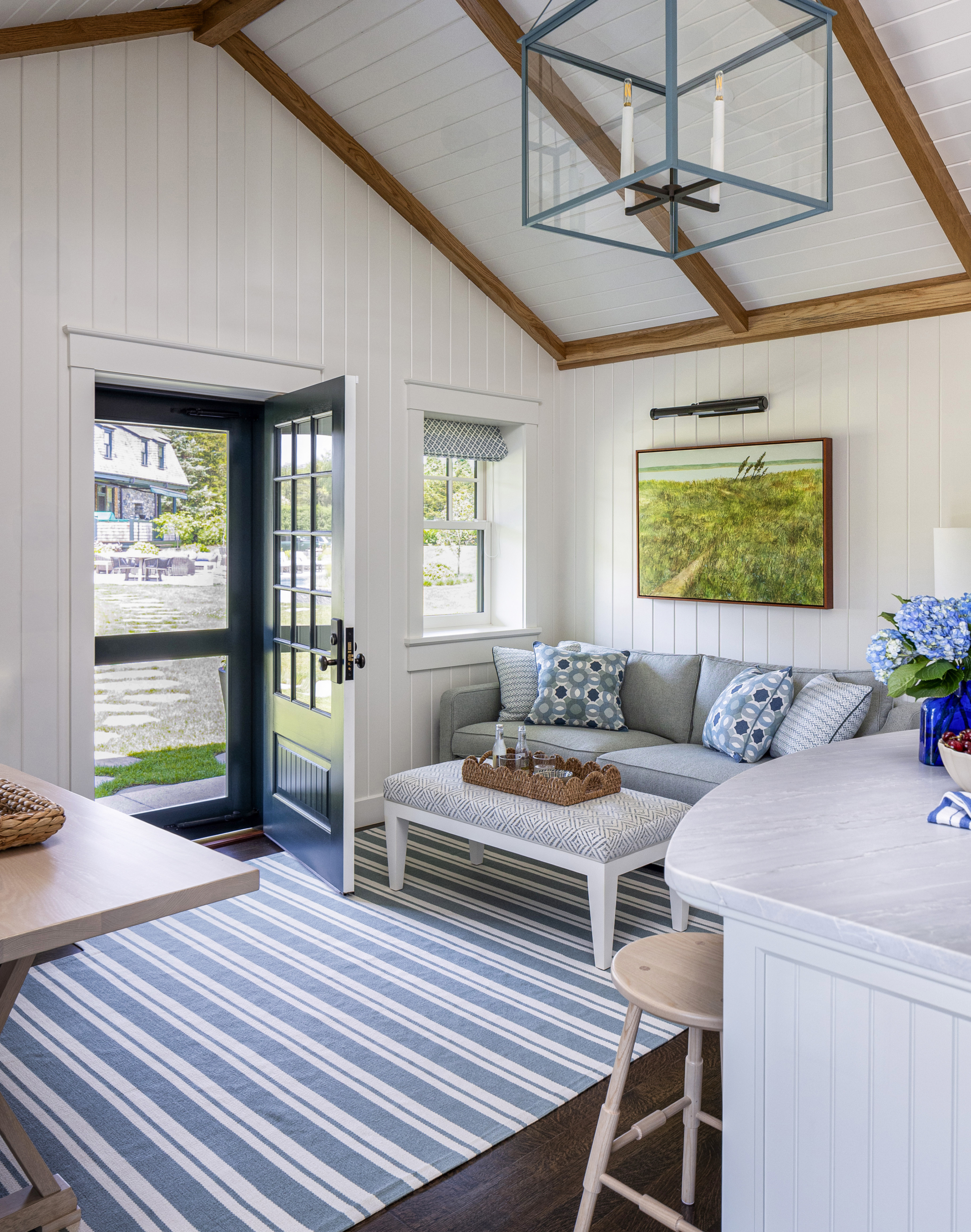 A guest house sitting area with striped rug and seating