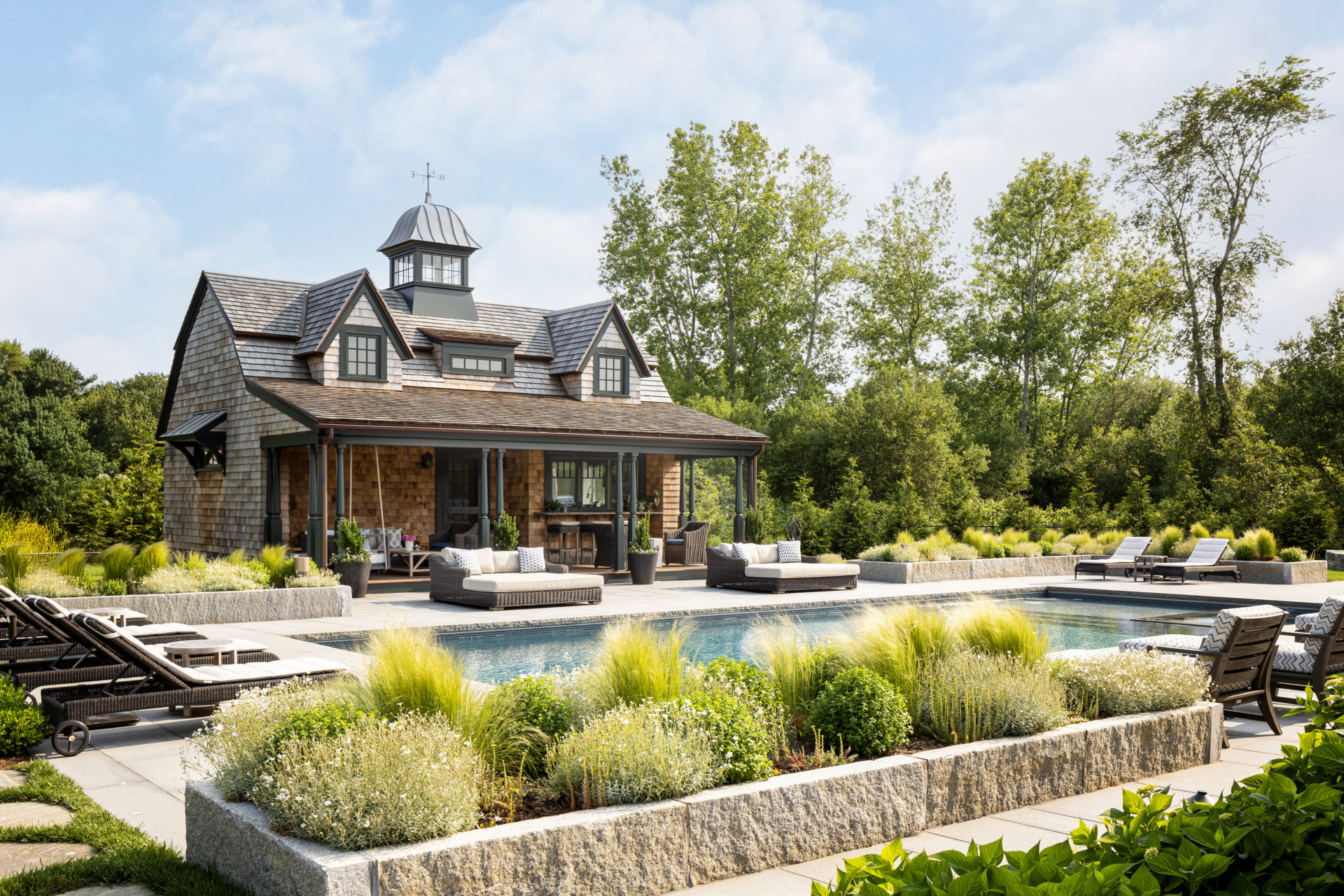 Landscaping around a pool and poolhouse in Rhode Island by Taste Design