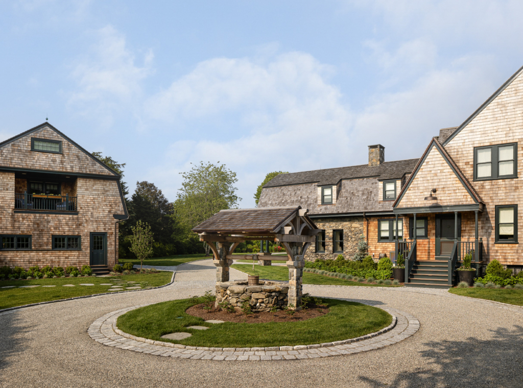 A restored historic stone well at a shingle-style farmhouse in Rhode Island
