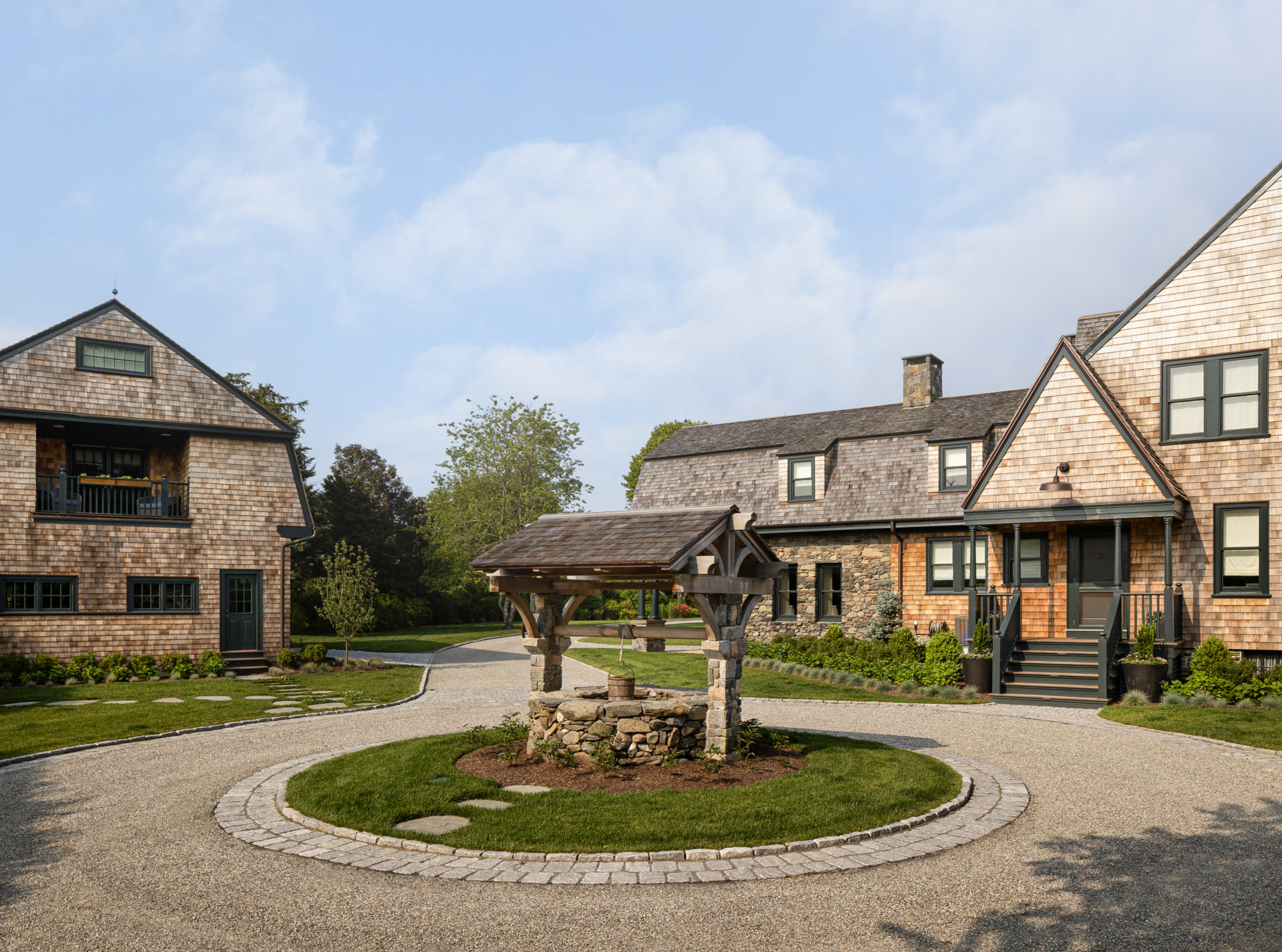 A restored historic stone well at a shingle-style farmhouse in Rhode Island
