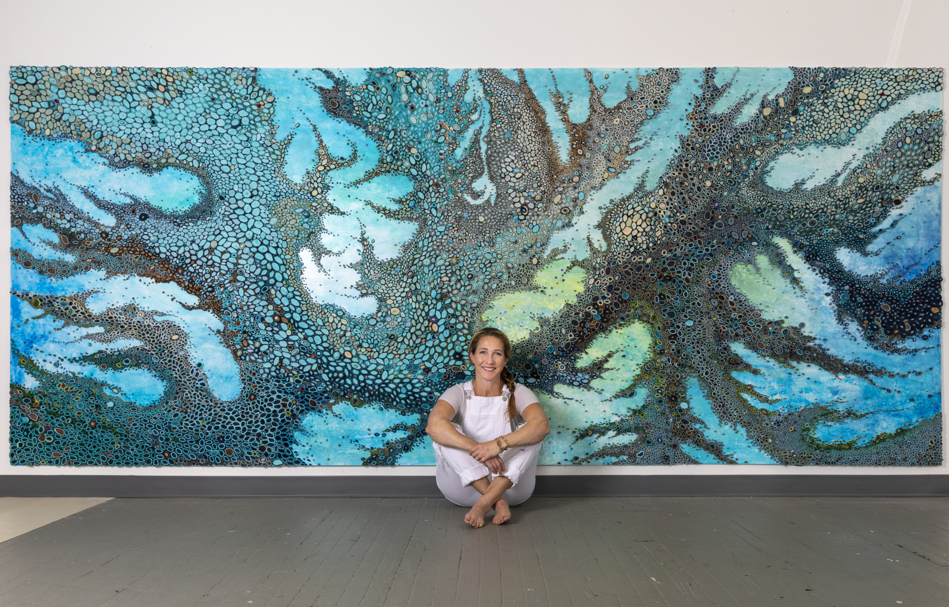 Amy Genser in front of her artwork