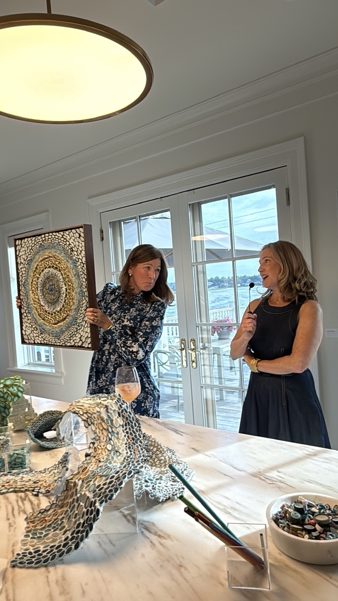 Patti Watson holds up artwork by Amy Genser