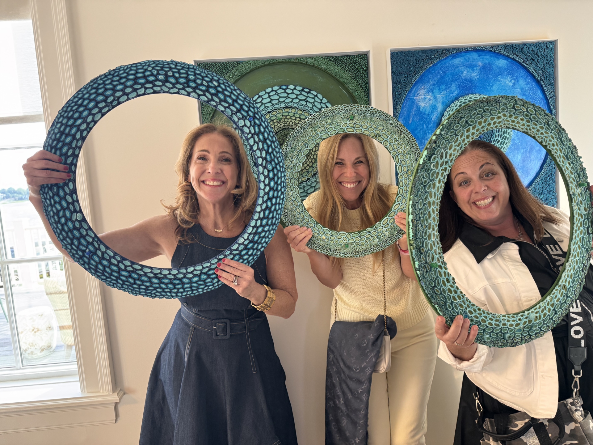 Amy Genser with friends and her magnetic circle artwork